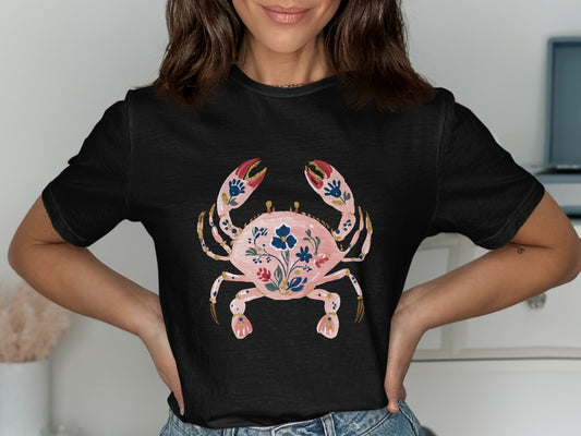 Black t-shirt with a pink crab design featuring floral patterns.