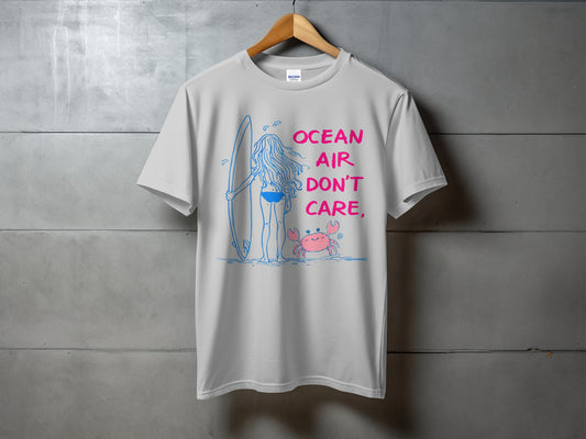 White t-shirt with "Ocean Air Don't Care" text, a surfer, and a crab graphic.