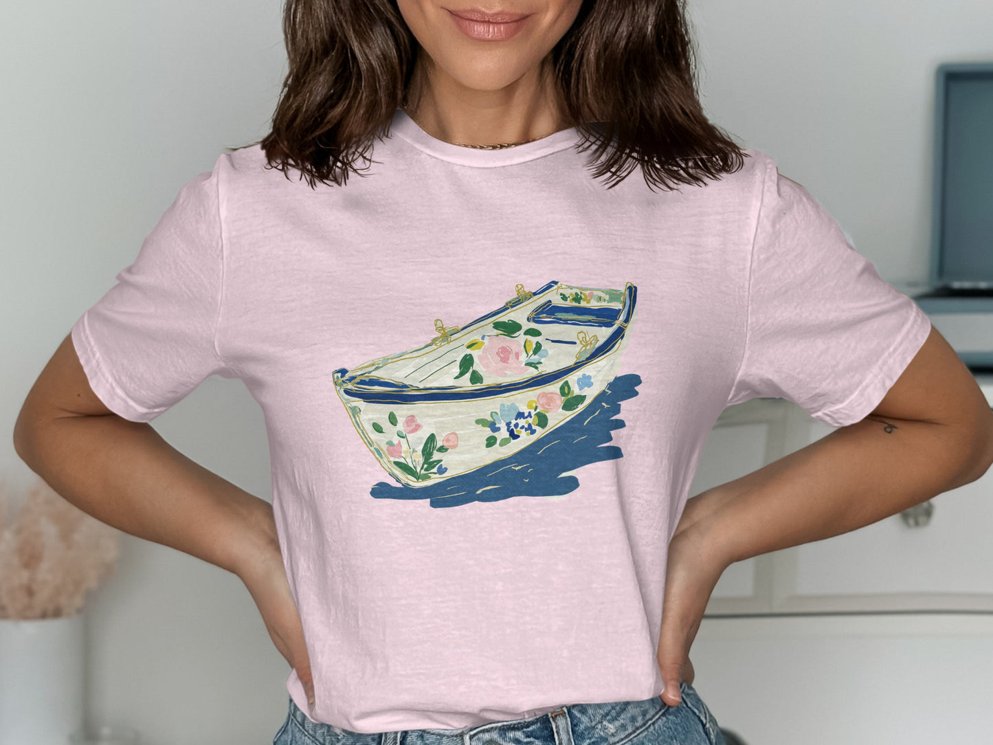 Pink t-shirt with a floral rowboat graphic design.
