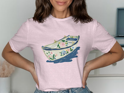 Pink t-shirt with a floral rowboat graphic design.