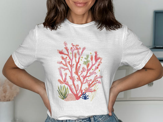 White t-shirt with a coral reef graphic design.