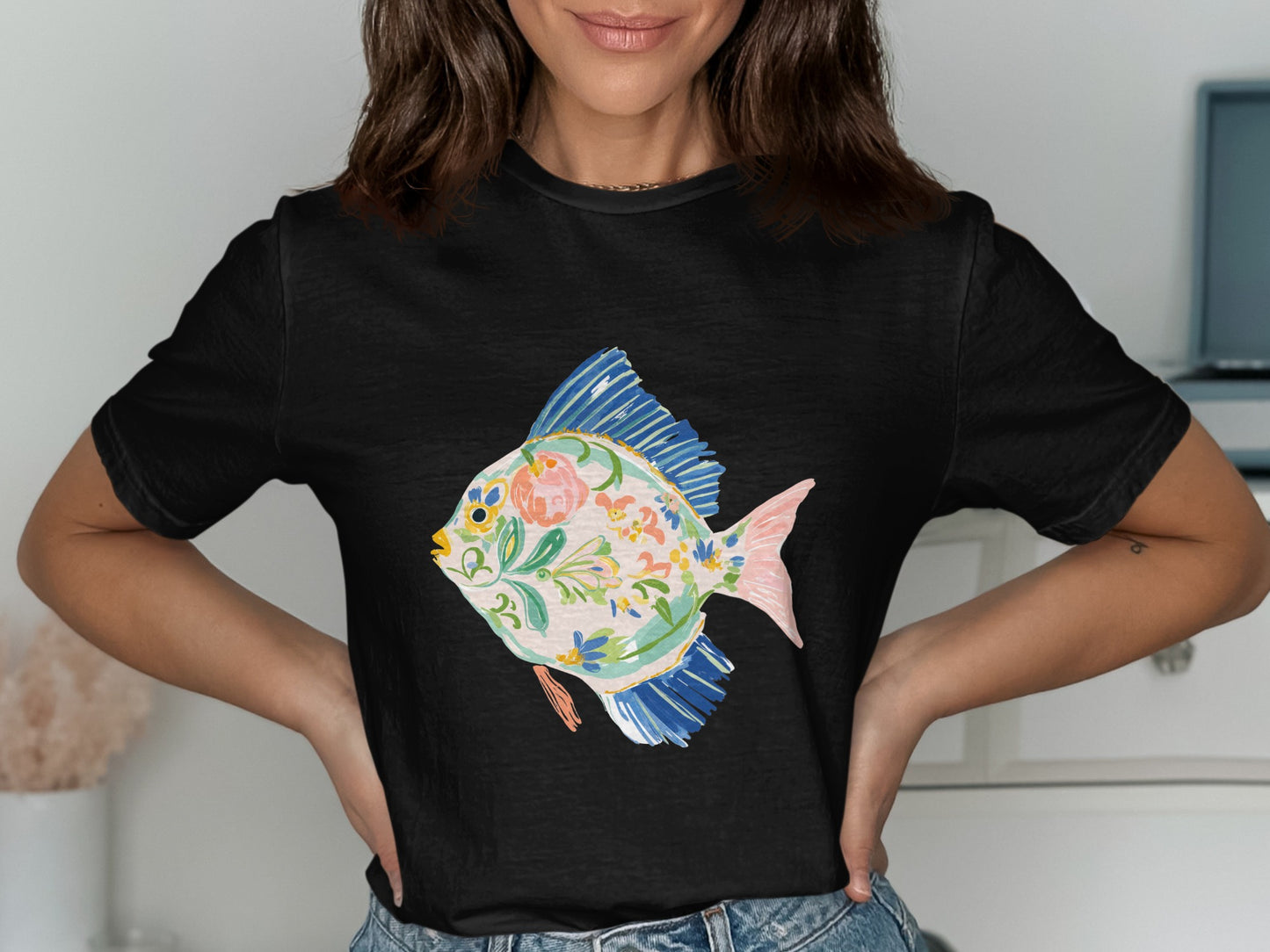 Black t-shirt with a colorful floral fish illustration.