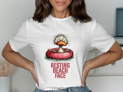 White t-shirt with a cartoon duck in an inner tube, text reads "RESTING BEACH FACE".