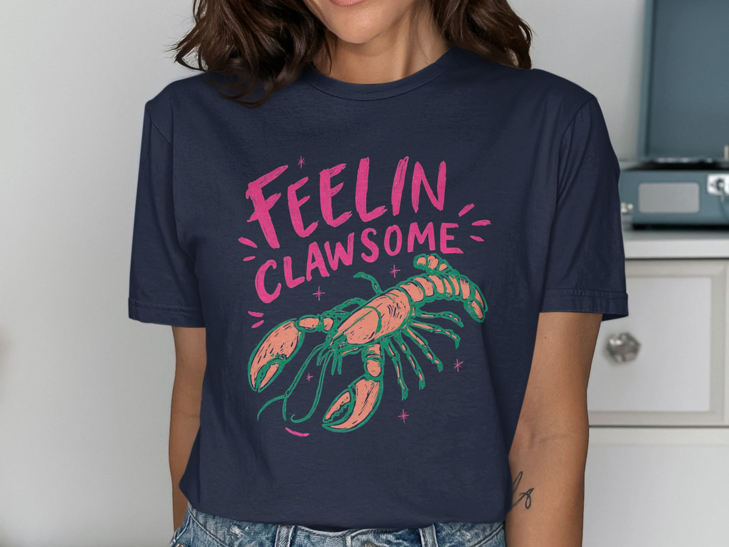 Navy t-shirt with a lobster graphic and text that reads "FEELIN CLAWSOME."