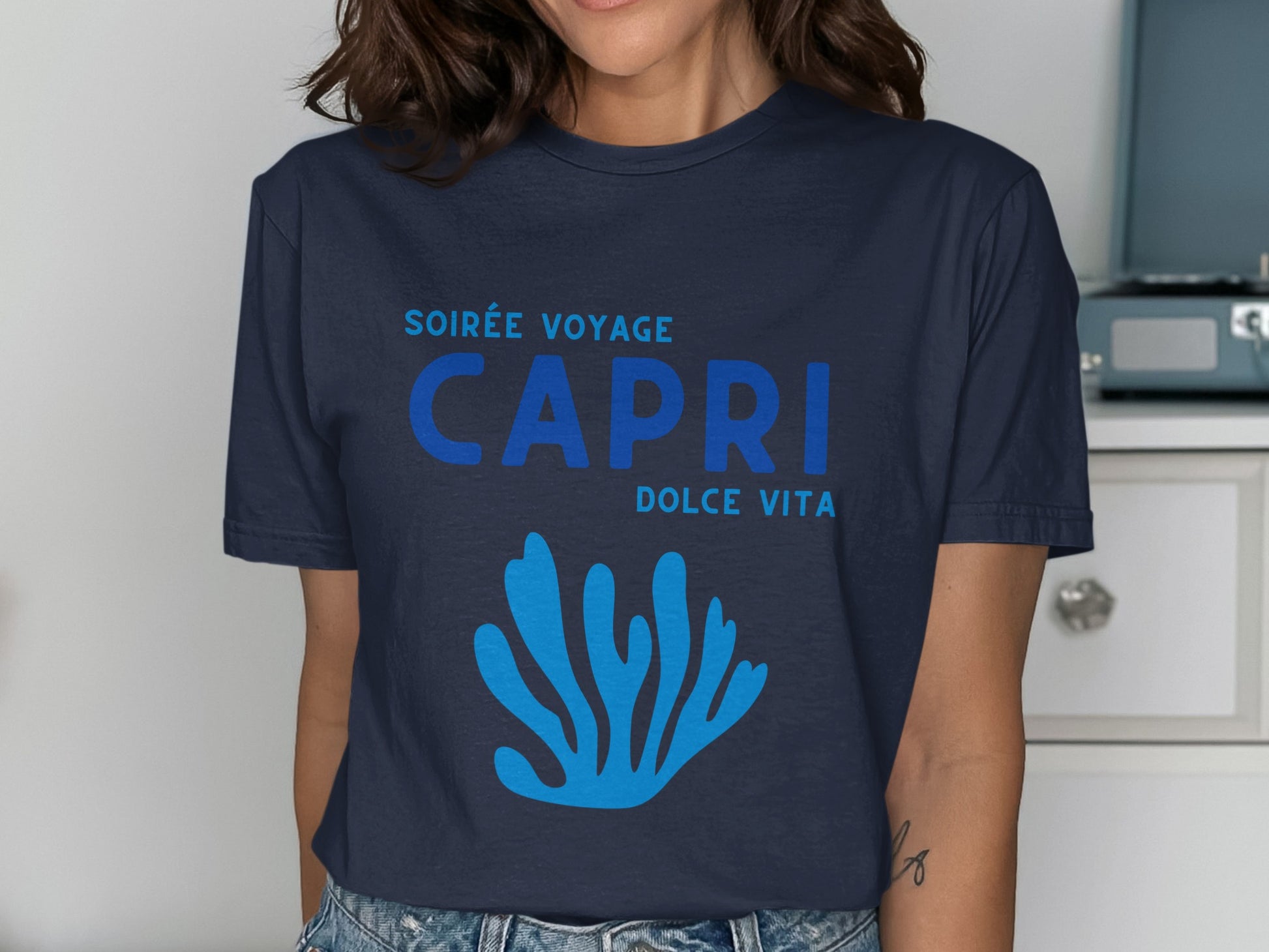 Navy t-shirt with blue "Soirée Voyage Capri Dolce Vita" text and coral graphic.