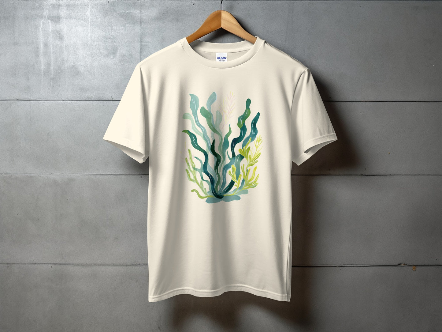 Cream t-shirt with abstract watercolor seaweed and plant design.