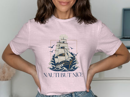Pink t-shirt with "Nauti But Nice" text and sailing ship illustration.