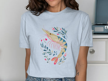 Light blue t-shirt with a watercolor shrimp and floral illustration.