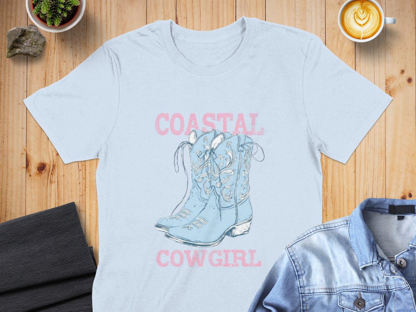 Light blue cowboy boots graphic on a pale blue t-shirt, text "COASTAL COWGIRL".