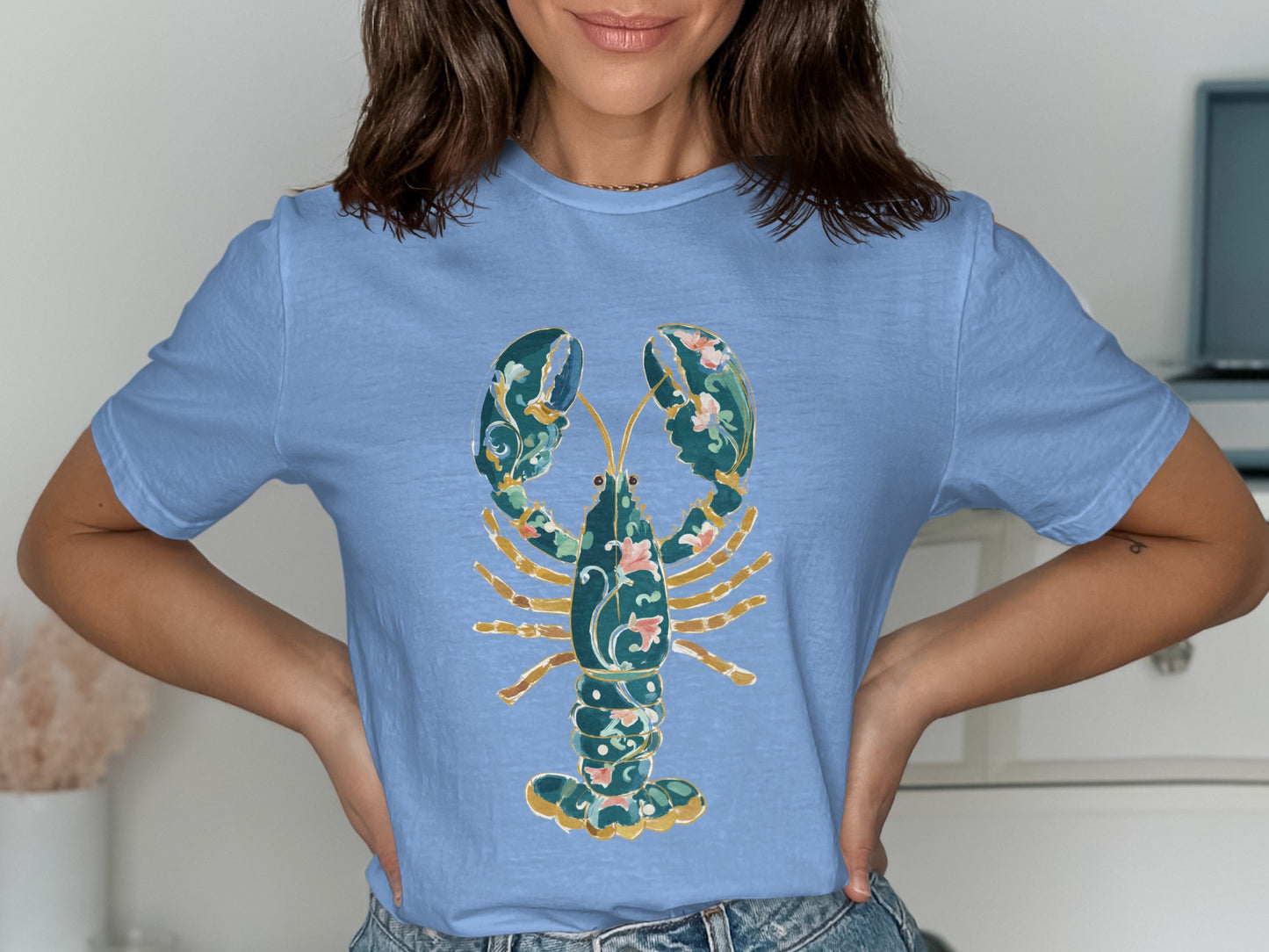 Light blue t-shirt with ornate teal lobster design.