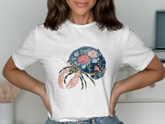 White t-shirt with a detailed floral hermit crab design.