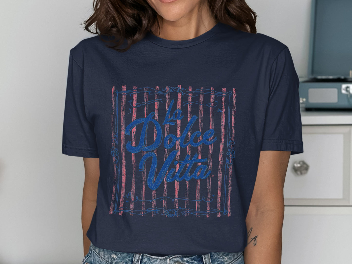 Navy t-shirt with "La Dolce Vita" text in blue over red stripes.