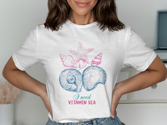 White t-shirt with seashells and "I need Vitamin Sea" text.