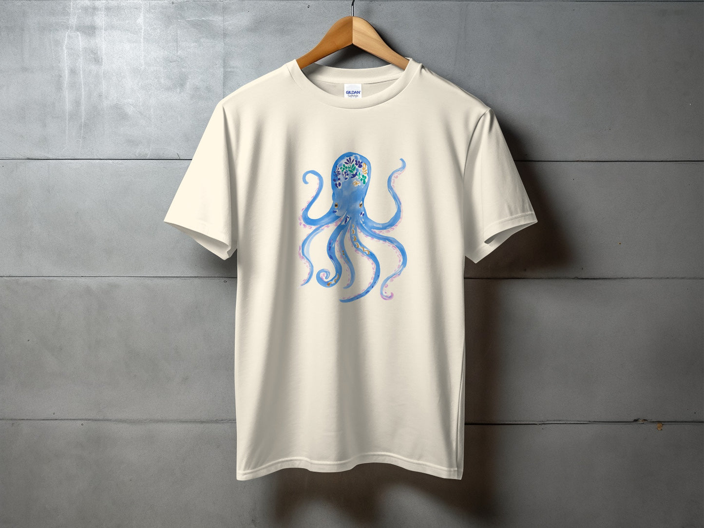 Light cream t-shirt with blue watercolor octopus graphic.