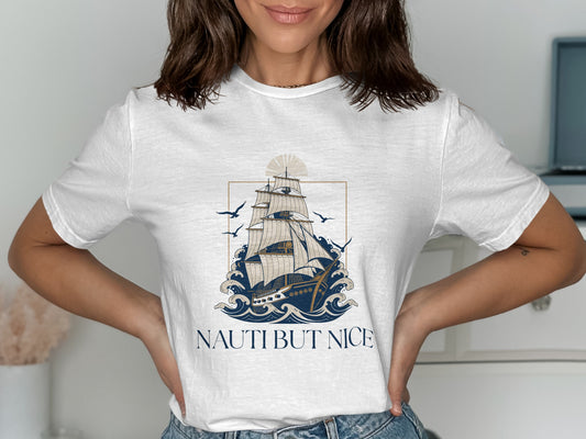 White t-shirt with a sailing ship on waves and "NAUTI BUT NICE" text.