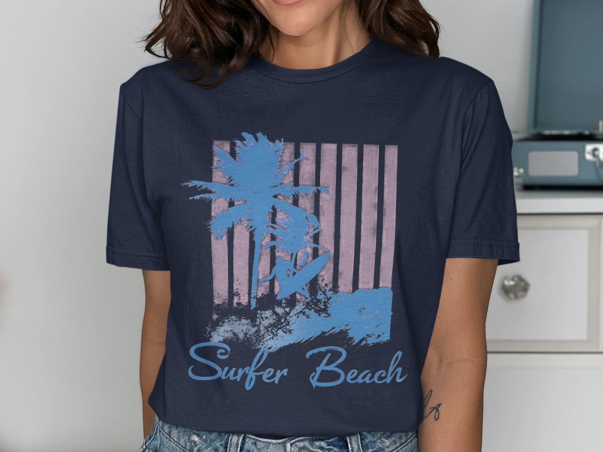 Navy t-shirt with a graphic of a surfer, palm tree, and waves.