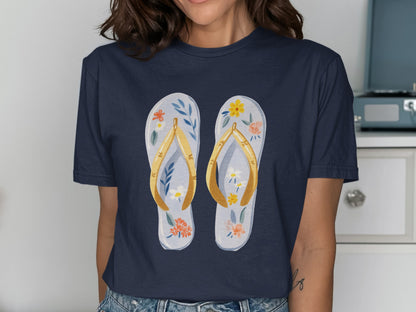 Navy t-shirt with watercolor flip-flops adorned with flowers.