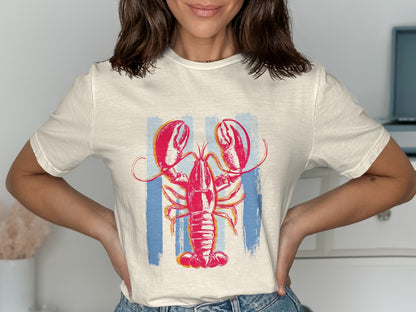 White t-shirt with a red lobster graphic and blue vertical stripes.