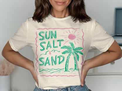 White t-shirt with "Sun Salt & Sand" text and palm tree graphic.