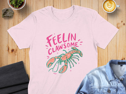 Pink t-shirt with "Feelin' Clawsome" text and cartoon lobster graphic.