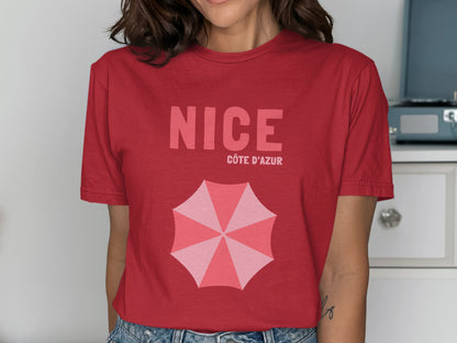 Red t-shirt with "NICE CÔTE D'AZUR" and an open pink umbrella graphic.