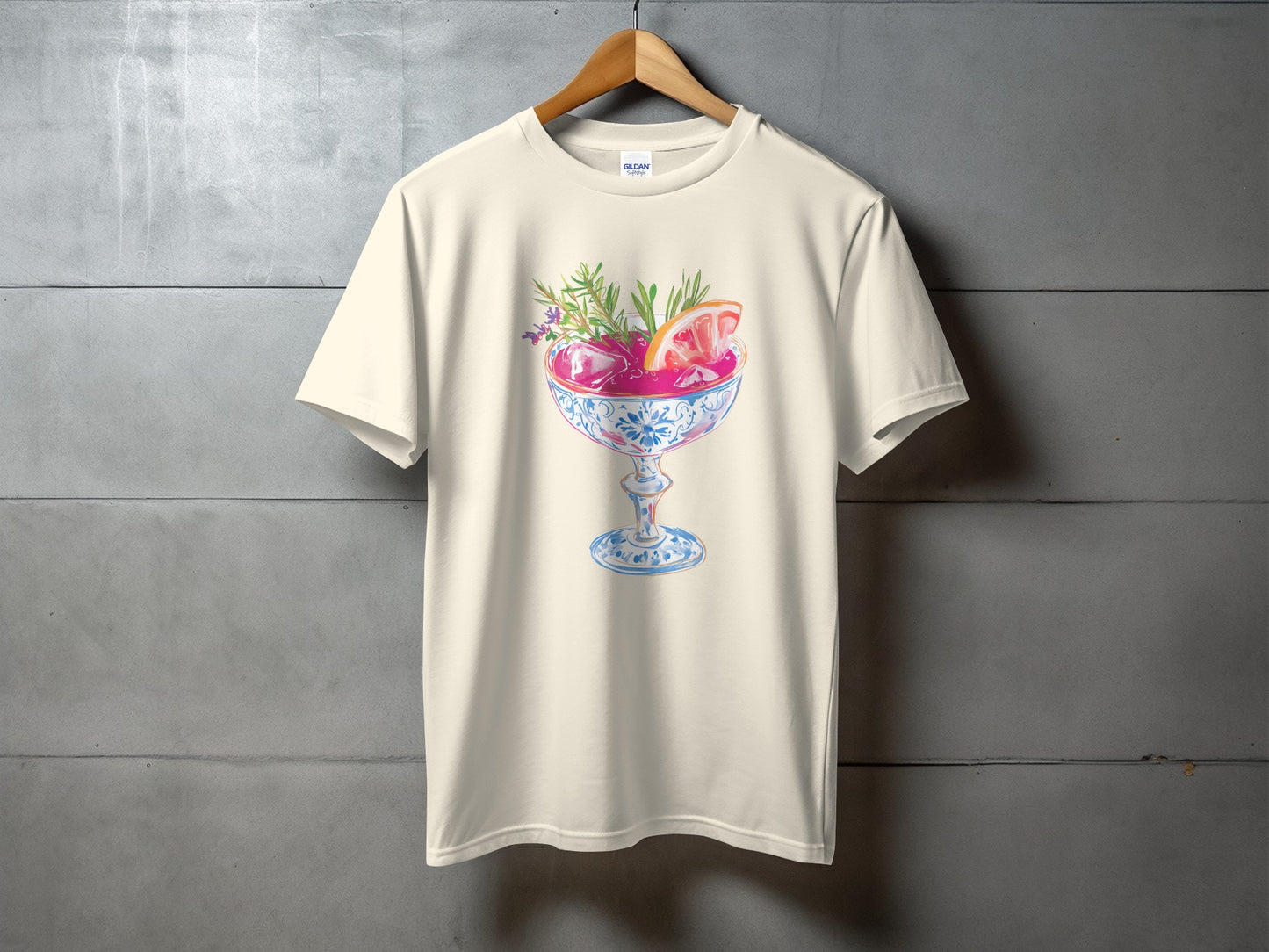 Cream t-shirt with cocktail illustration, garnished with grapefruit and herbs.