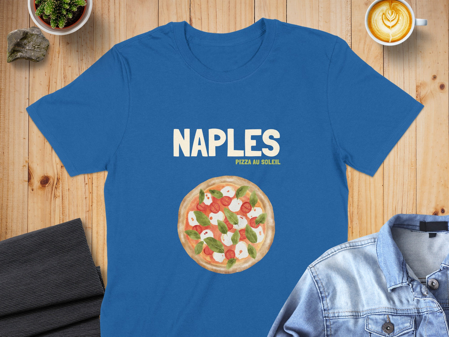 Blue t-shirt with a graphic of a pizza featuring "NAPLES PIZZA AU SOLEIL".