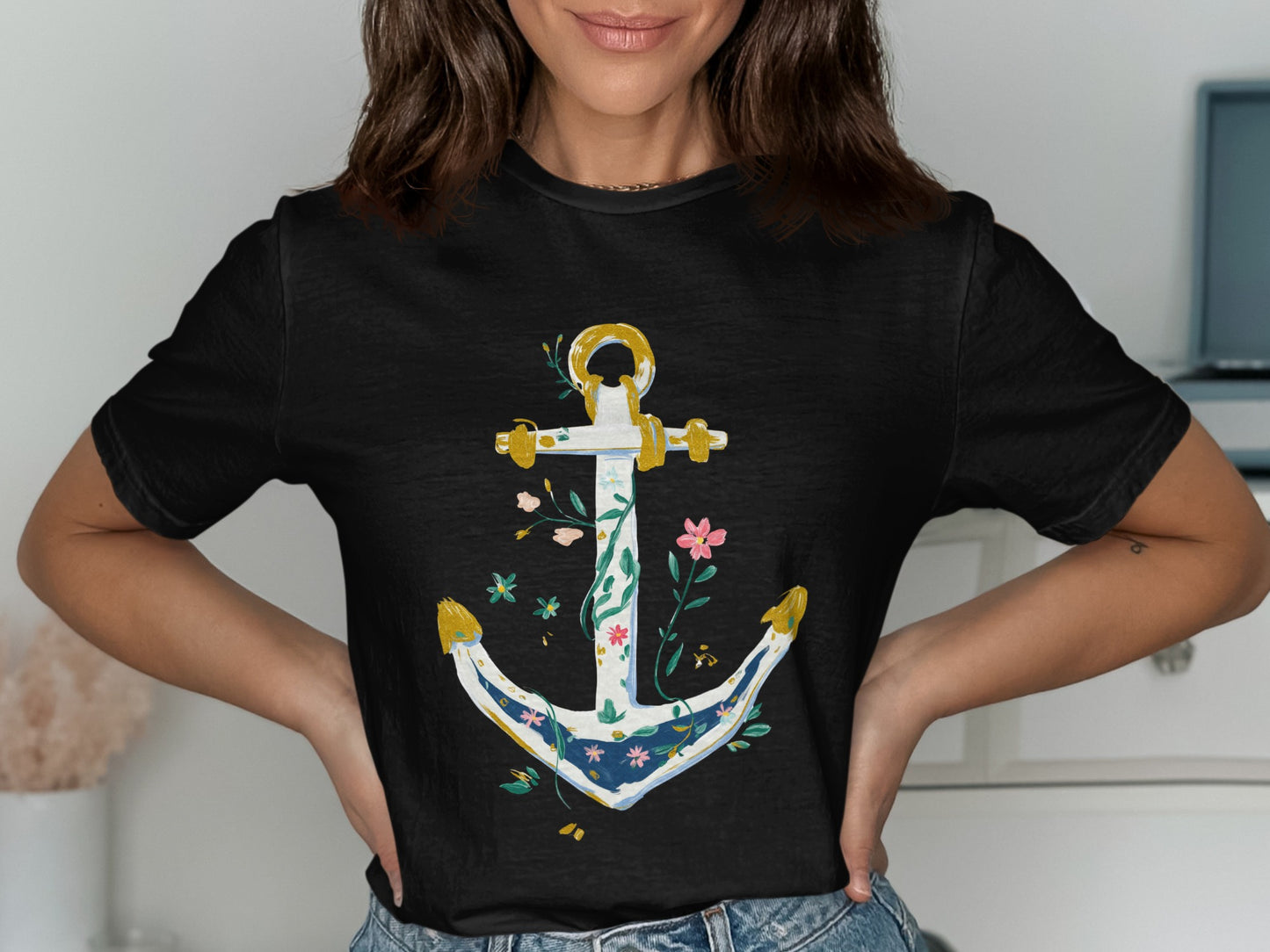 Black t-shirt with a white, blue, and gold anchor design with floral accents.