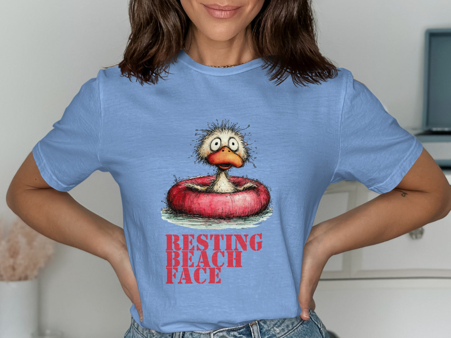 T-shirt with cartoon duck in inner tube, "Resting Beach Face" text.