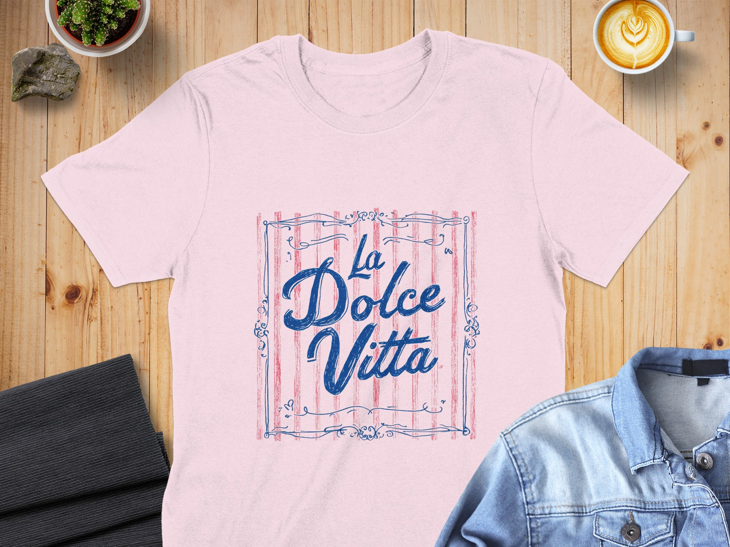 Pink t-shirt with "La Dolce Vita" text in a decorative frame.