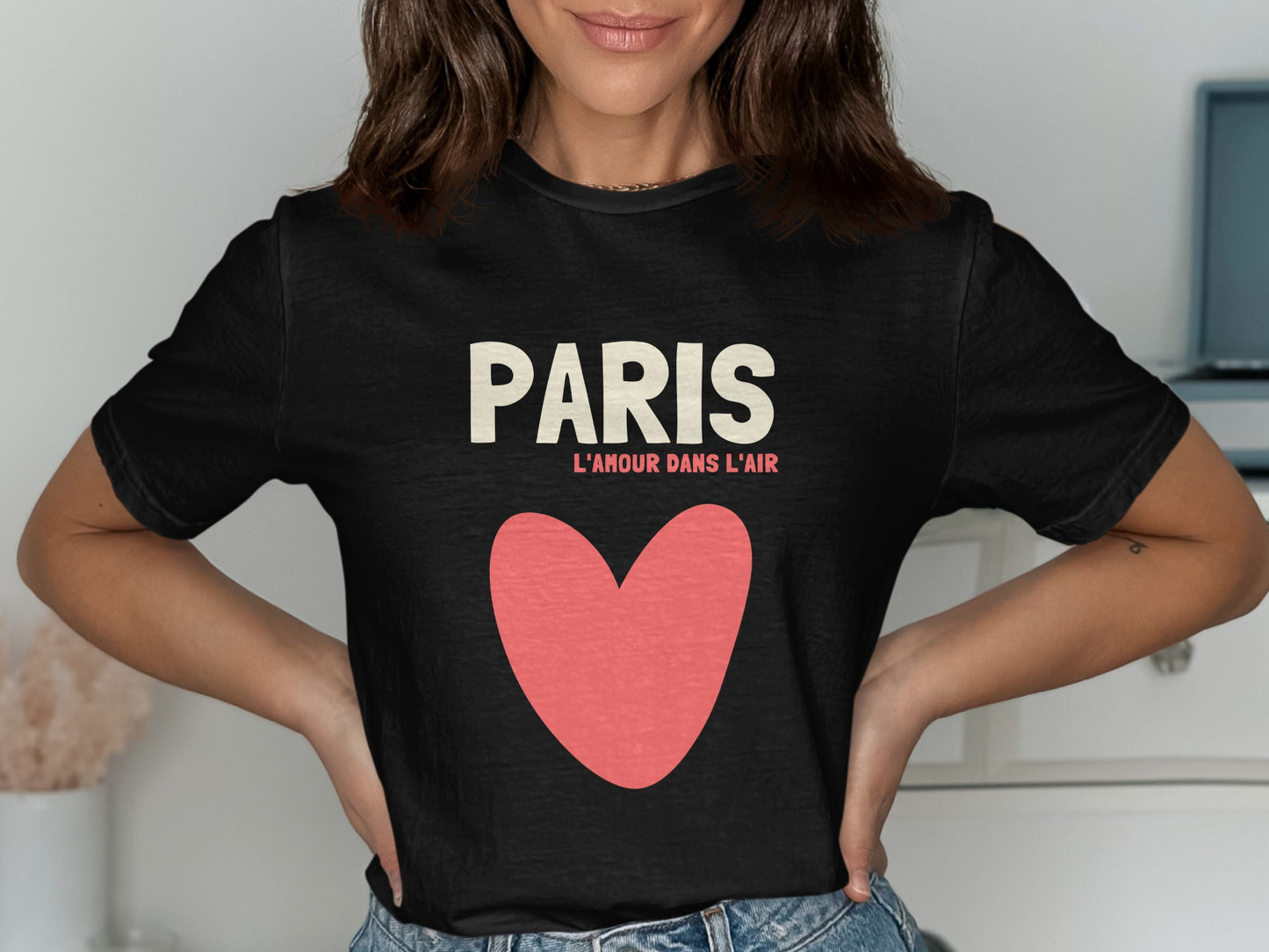 Black t-shirt with "PARIS L'AMOUR DANS L'AIR" text and a large pink heart.
