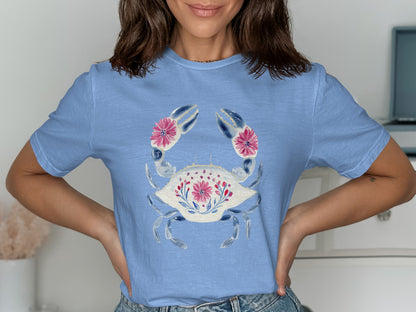 Light blue t-shirt featuring a stylized crab with pink floral accents.