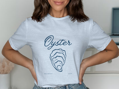 White t-shirt with "Oyster" text and graphic, "WHATEVER'S GREATEST" and date.