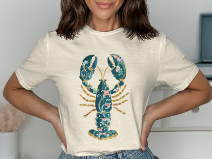 Cream t-shirt with a detailed blue lobster and floral design.