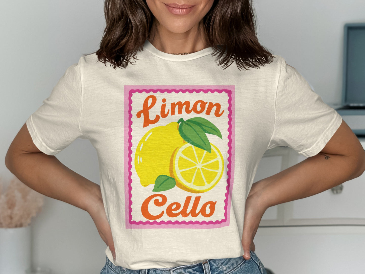 Cream t-shirt with pink border and "Limoncello" text above a lemon illustration.