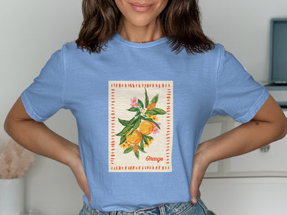 Light blue t-shirt with a sketch of an orange branch and "Orange" text.