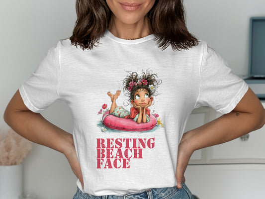 White t-shirt featuring a cartoon girl on a pink float, "Resting Beach Face" text.
