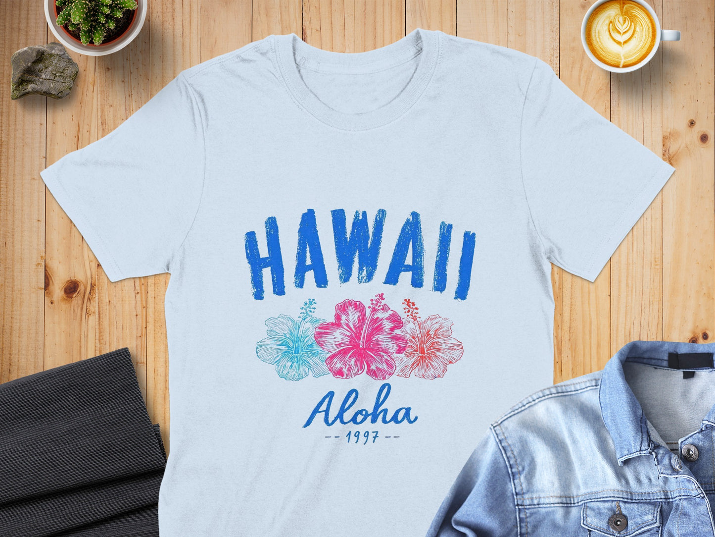 Light blue t-shirt with "HAWAII Aloha 1997" and hibiscus flowers.