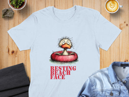 Light blue t-shirt with distressed "RESTING BEACH FACE" text and cartoon duck in inner tube.