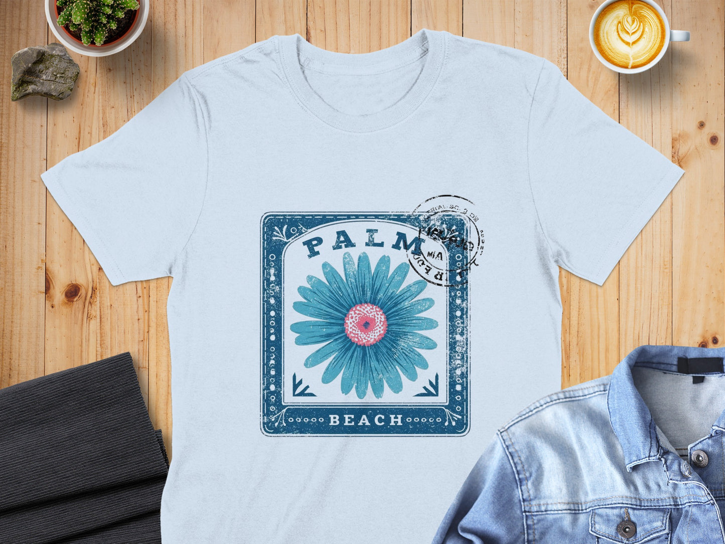 Blue daisy graphic with "Palm Beach" text on a white t-shirt.
