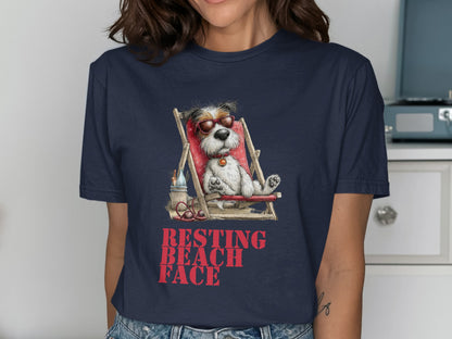 Dog in sunglasses relaxing on a beach chair with text "RESTING BEACH FACE".