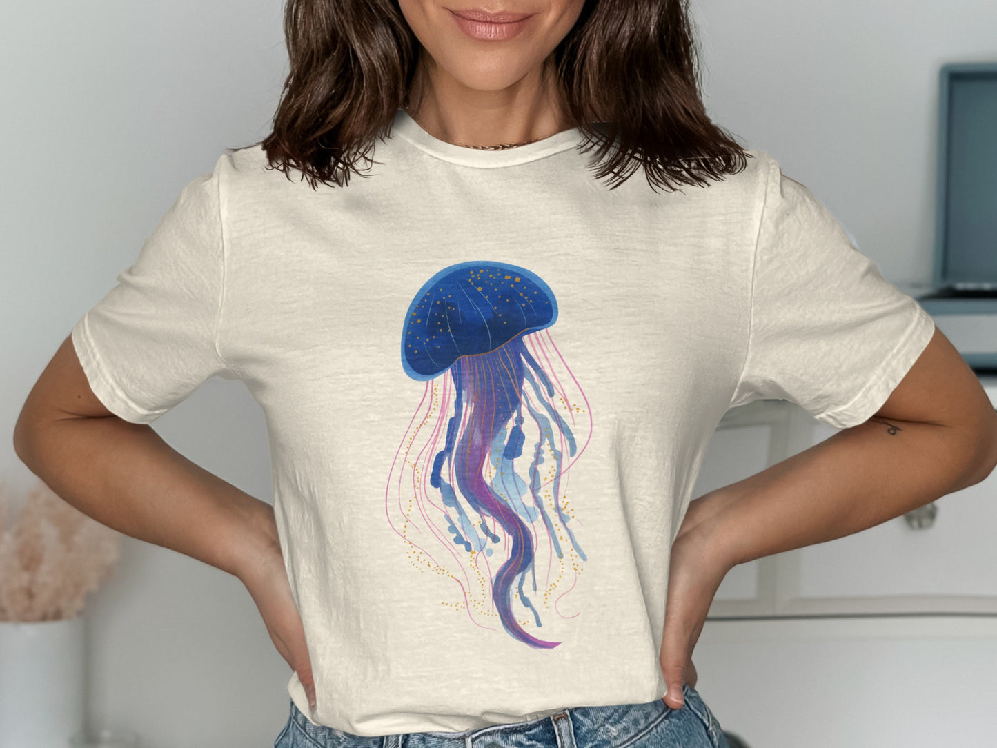 Cream t-shirt with a blue and pink watercolor jellyfish design.