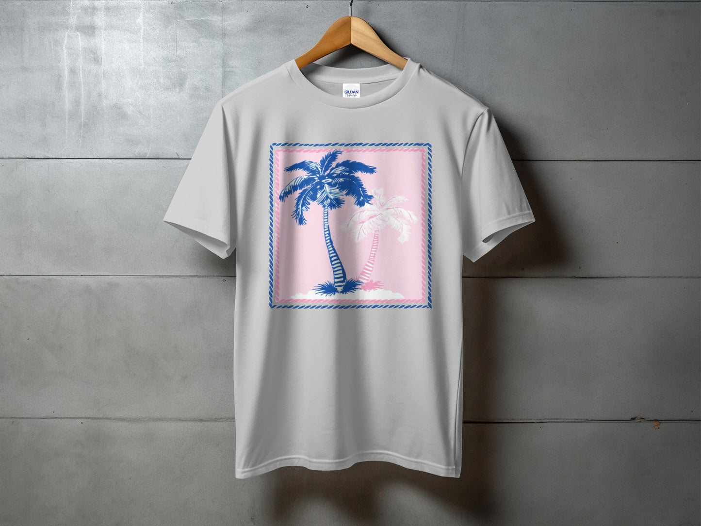 Gray t-shirt with blue and pink palm trees on a pink background.
