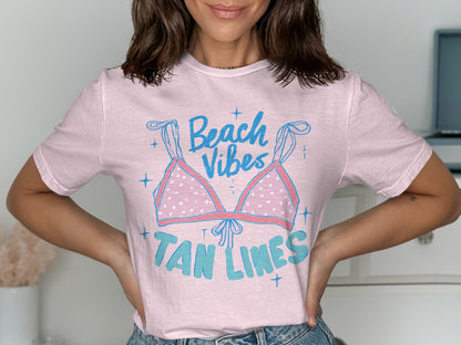 Light pink t-shirt with "Beach Vibes Tan Lines" text and bikini graphic.