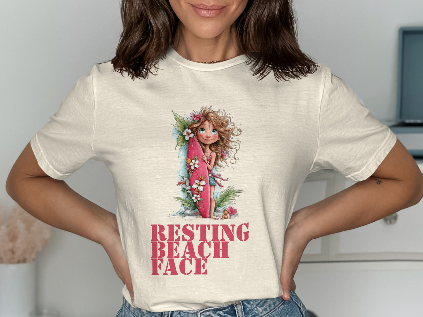 Woman in t-shirt with a girl holding a surfboard graphic.