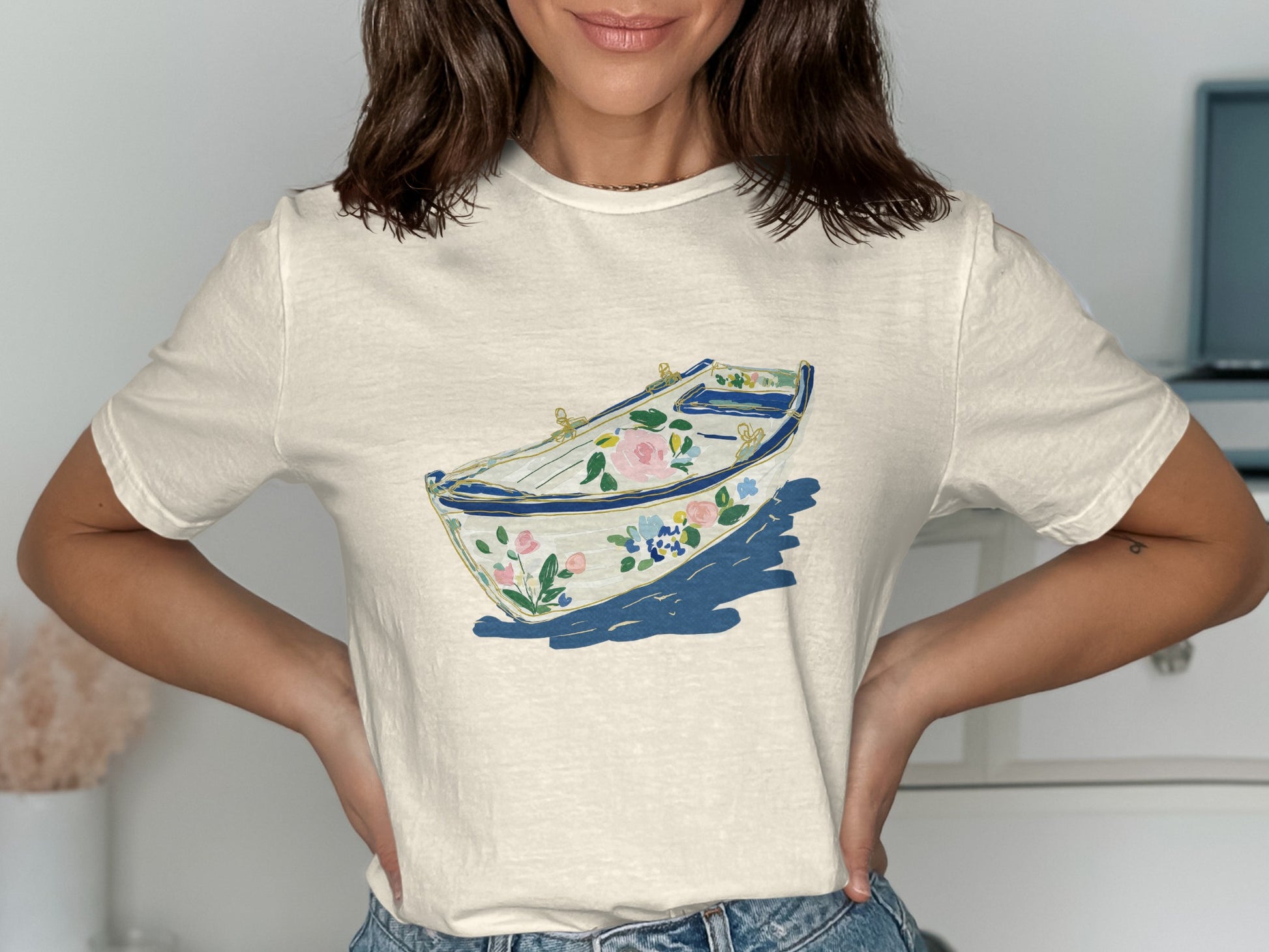 Cream t-shirt with floral rowboat illustration.