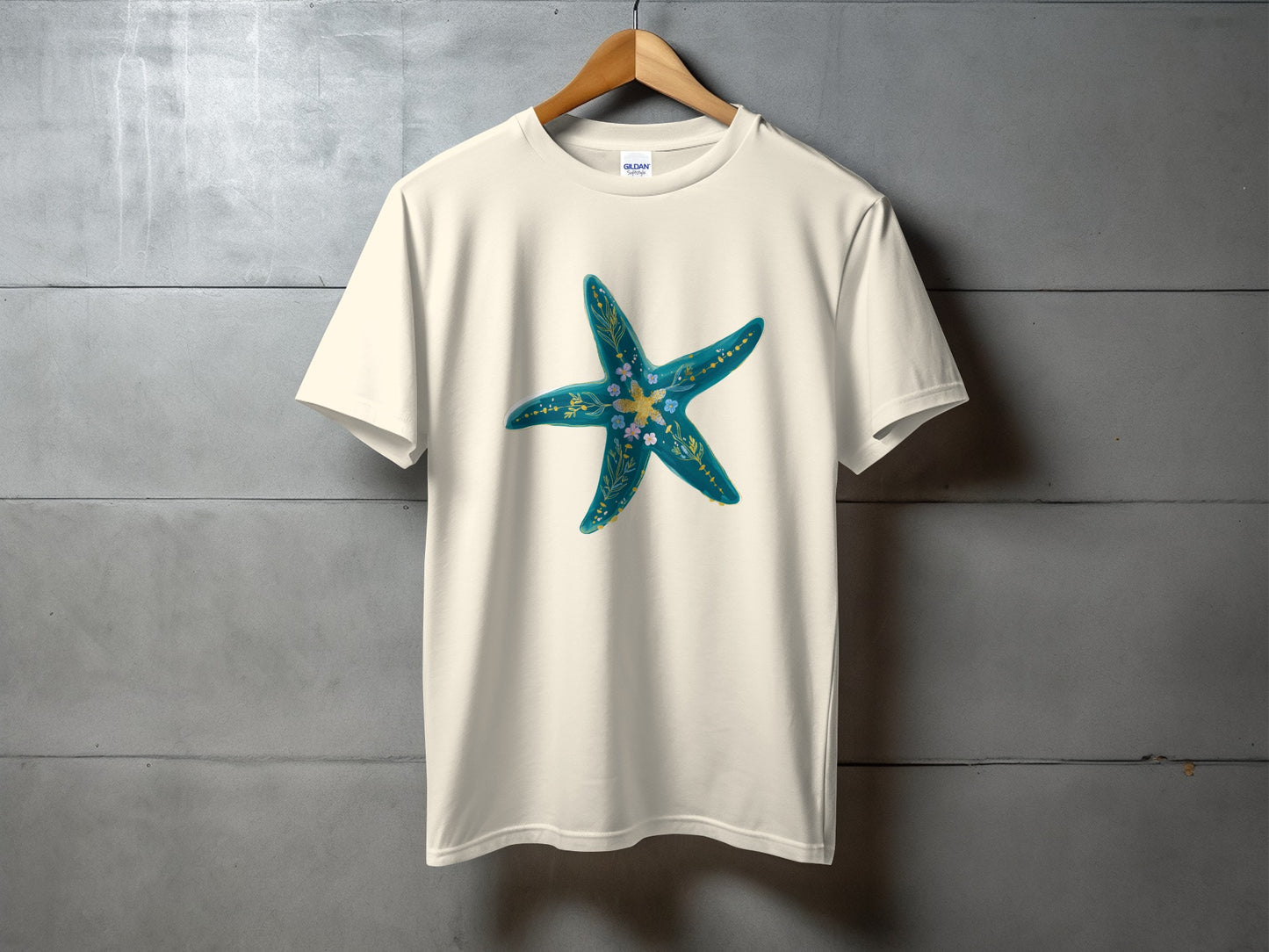 Cream t-shirt with a teal and gold starfish design.