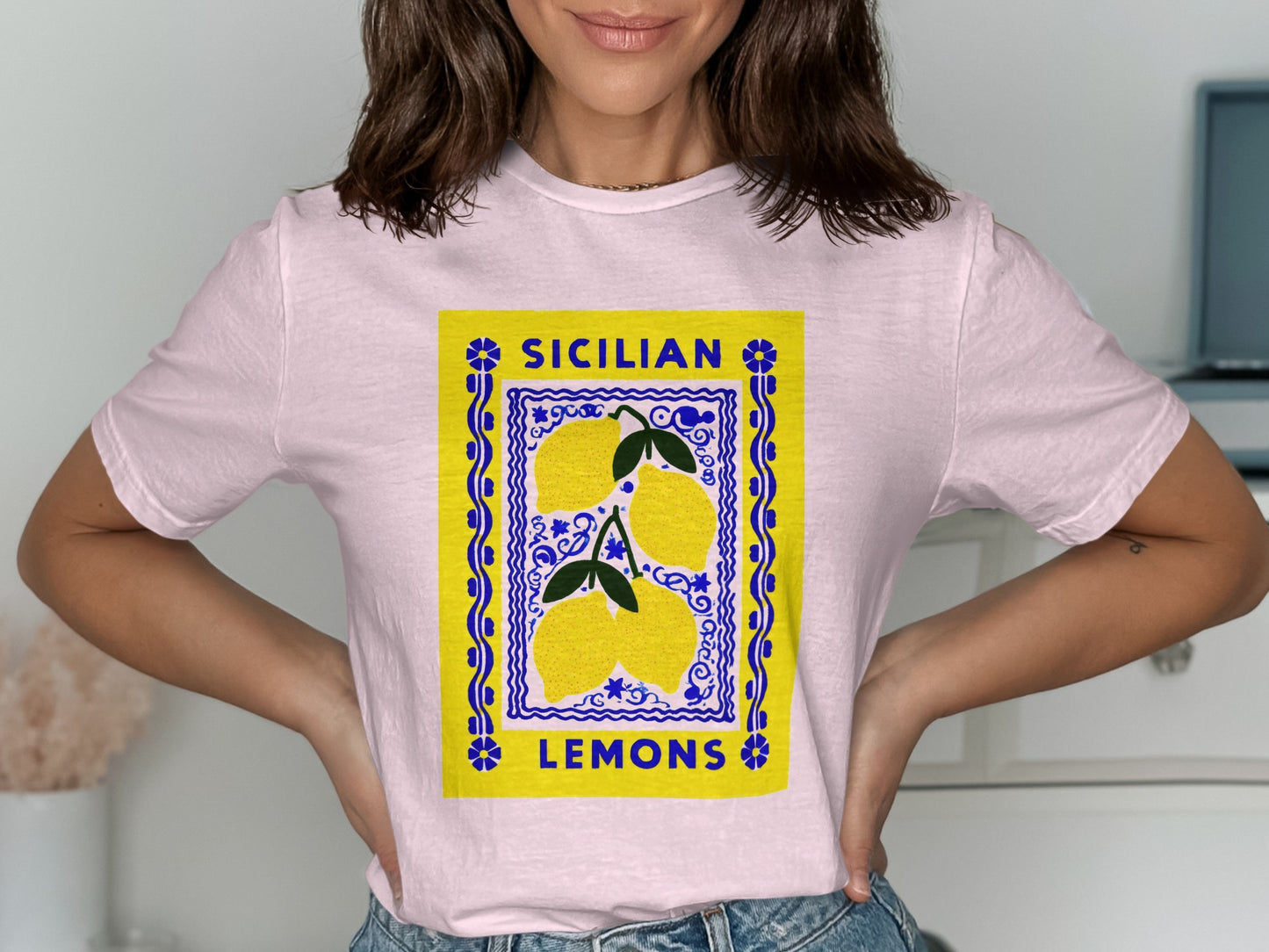 Pink t-shirt with a yellow label featuring three lemons and "SICILIAN LEMONS" text.