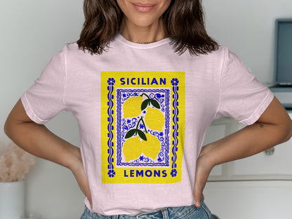 Pink t-shirt with a yellow label featuring three lemons and "SICILIAN LEMONS" text.