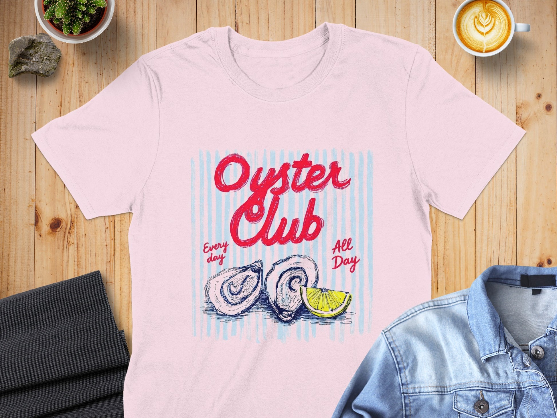 Pink t-shirt with "Oyster Club" text, two oysters, and lemon slice.